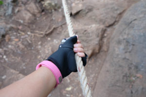 woman's hand climbing mountain
